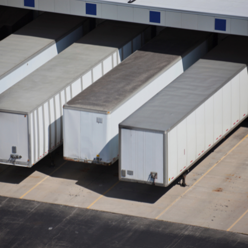 A mix of older and new dry van trailers.
