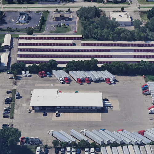 Dock & Transfer Yard showing truck parking, trailer dropping, warehouse space, and a local fleet parked in the lot.